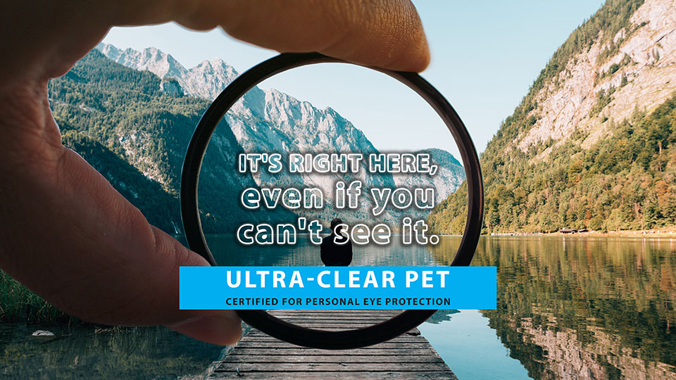 Cerified for eye protection ultra-clear PET plastic news cover, PET lens on the background of mountain lake view